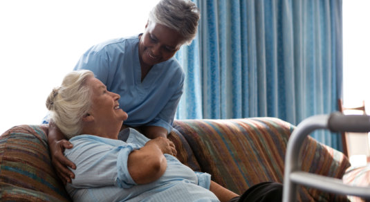 caregiver giving care to elder woman