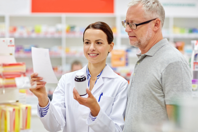 pharmacist follow the prescription guide of the medicine of senior man